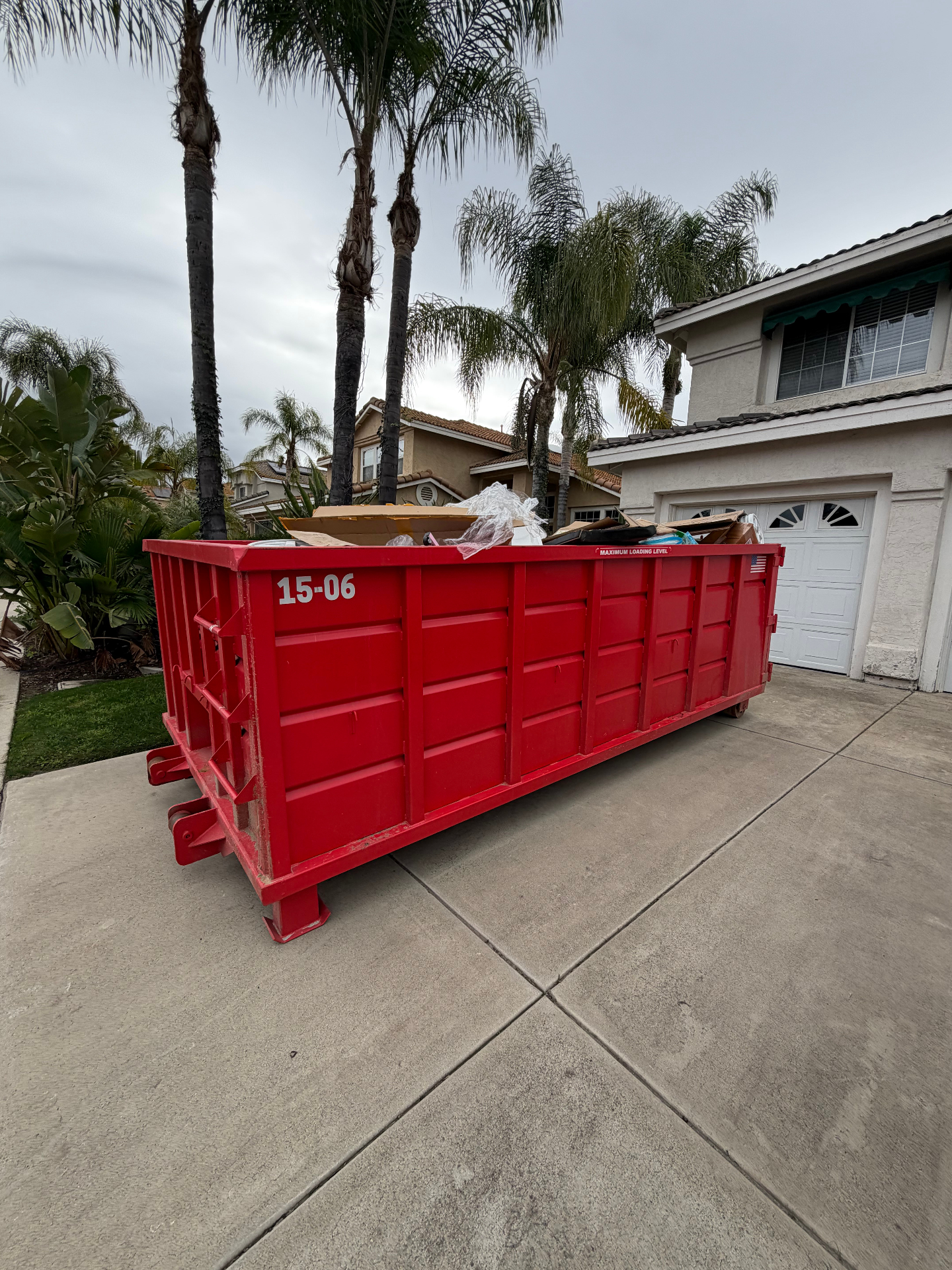 Completed garage cleanout with full Victory Dumpster Rentals roll-off dumpster ready for pickup in Temecula Valley, CA
