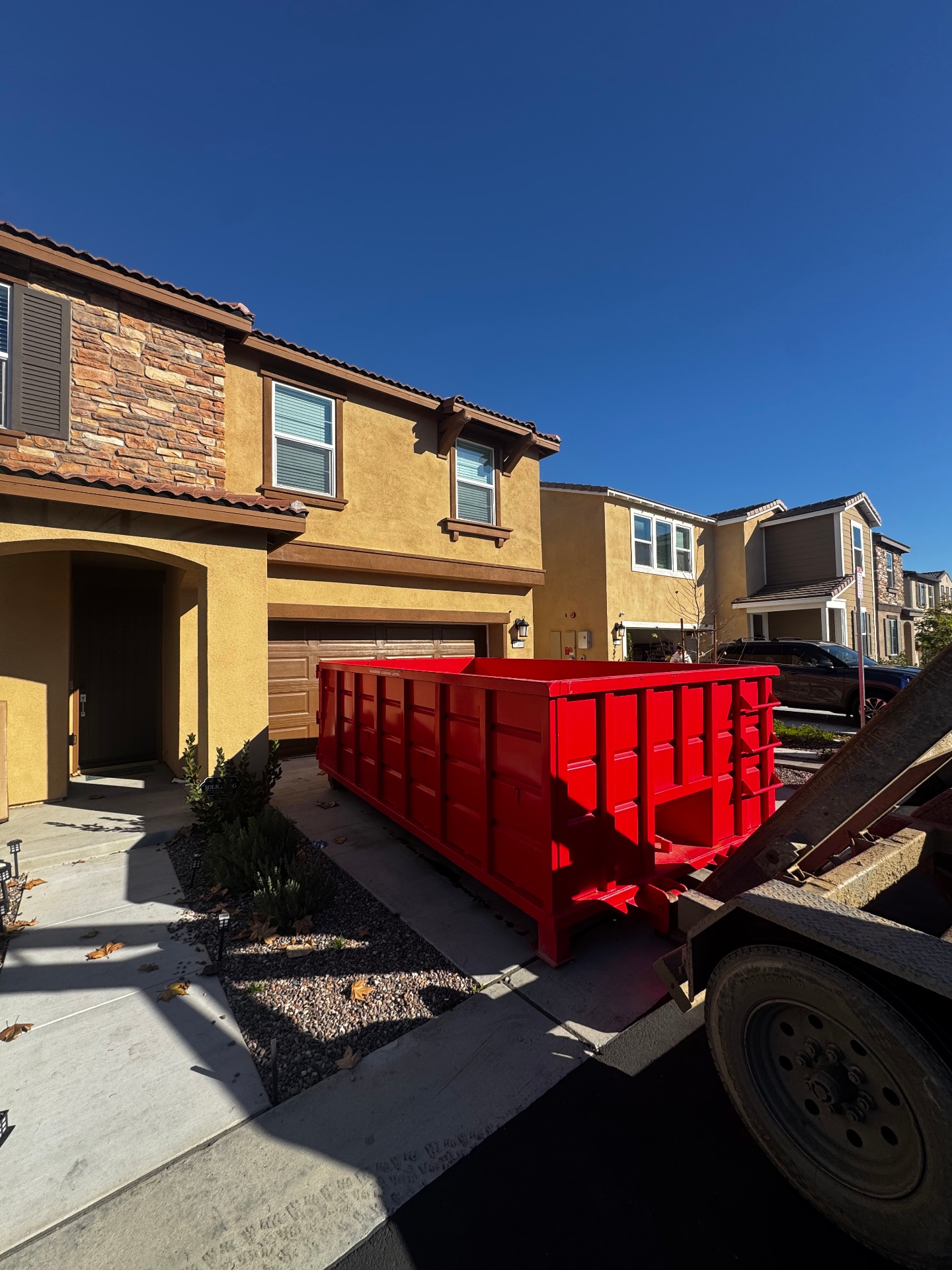 Kitchen remodel debris including cabinets and tile loaded into a Victory Dumpster Rentals roll-off dumpster in Temecula Valley, CA