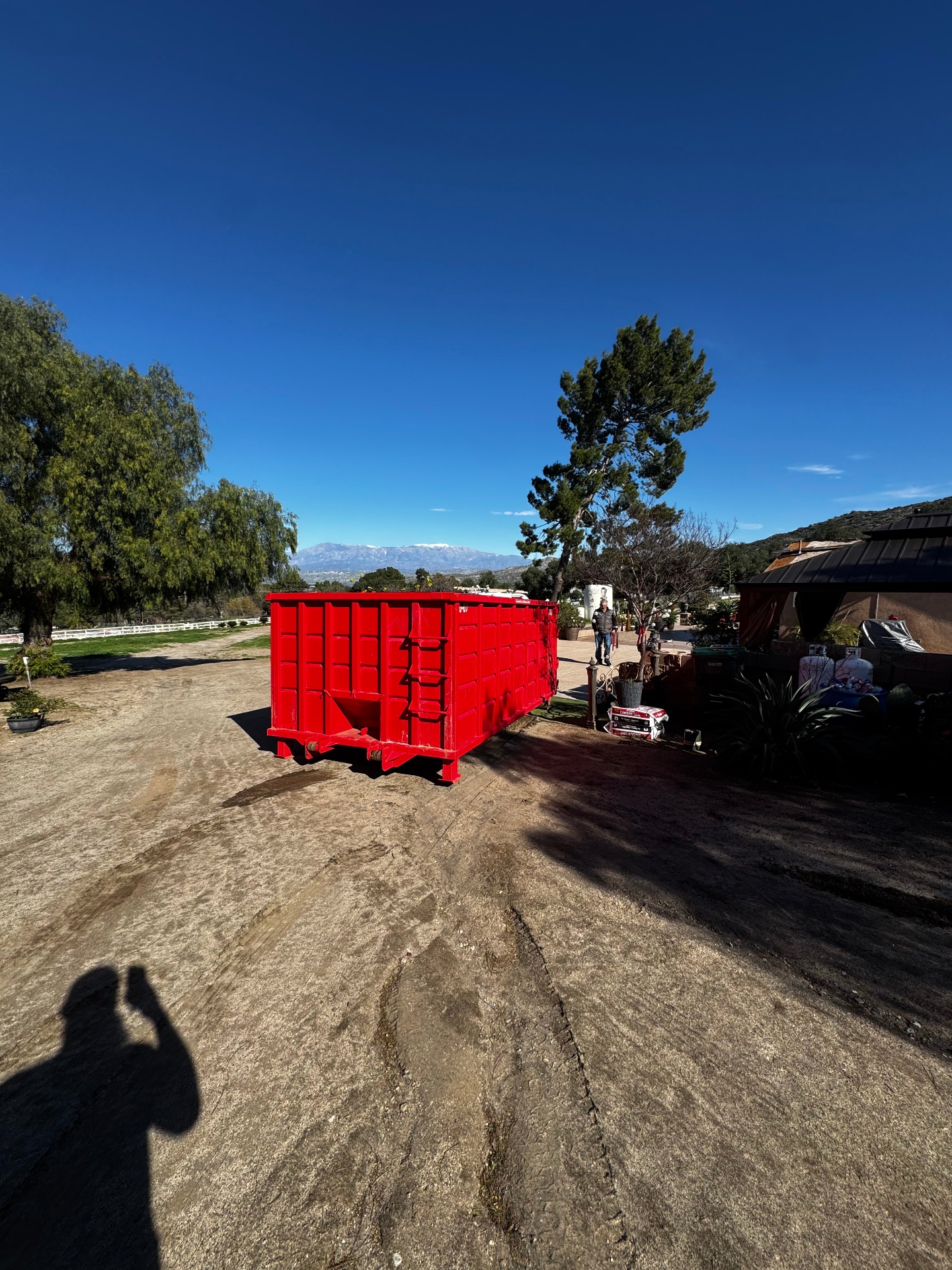 Roofing tear-off with Victory Dumpster Rentals roll-off dumpster positioned below for shingle disposal in Temecula Valley, CA